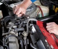 A mechanic is repairing a car's engine.