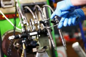 Mechanic Working With Fuel Injector - Fuel Injector Repair Near Me in West Jordan - Ace Auto Repair