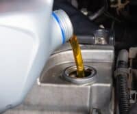 Expert mechanic performing oil change service at Ace Auto Repair in Utah.