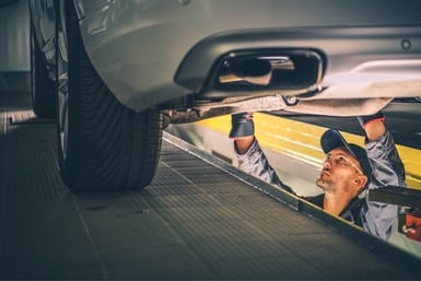 Auto Technician working under an automobile - Transmission Repair Specialists in West Jordan, Utah