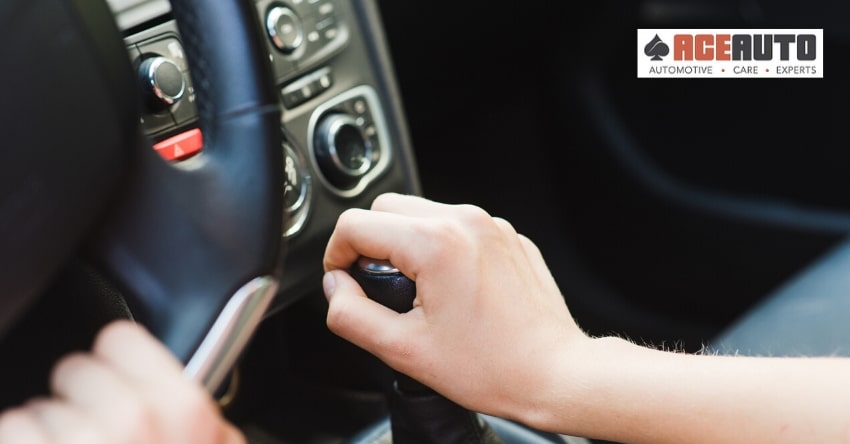 Hand on the gear shifter - What Causes Gears to Grind?