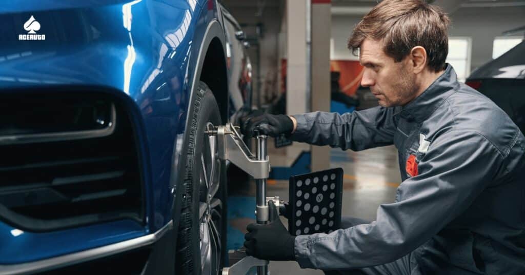 Mechanic performing wheel alignment on car using precision equipment