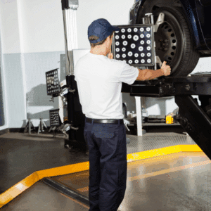 Car lifted in shop during digital wheel alignment service