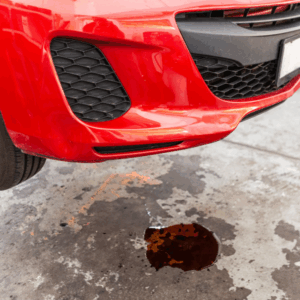 Transmission fluid leak under a vehicle in auto shop