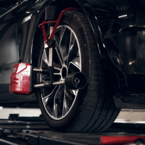 Vehicle on alignment rack with computer sensors measuring suspension angles